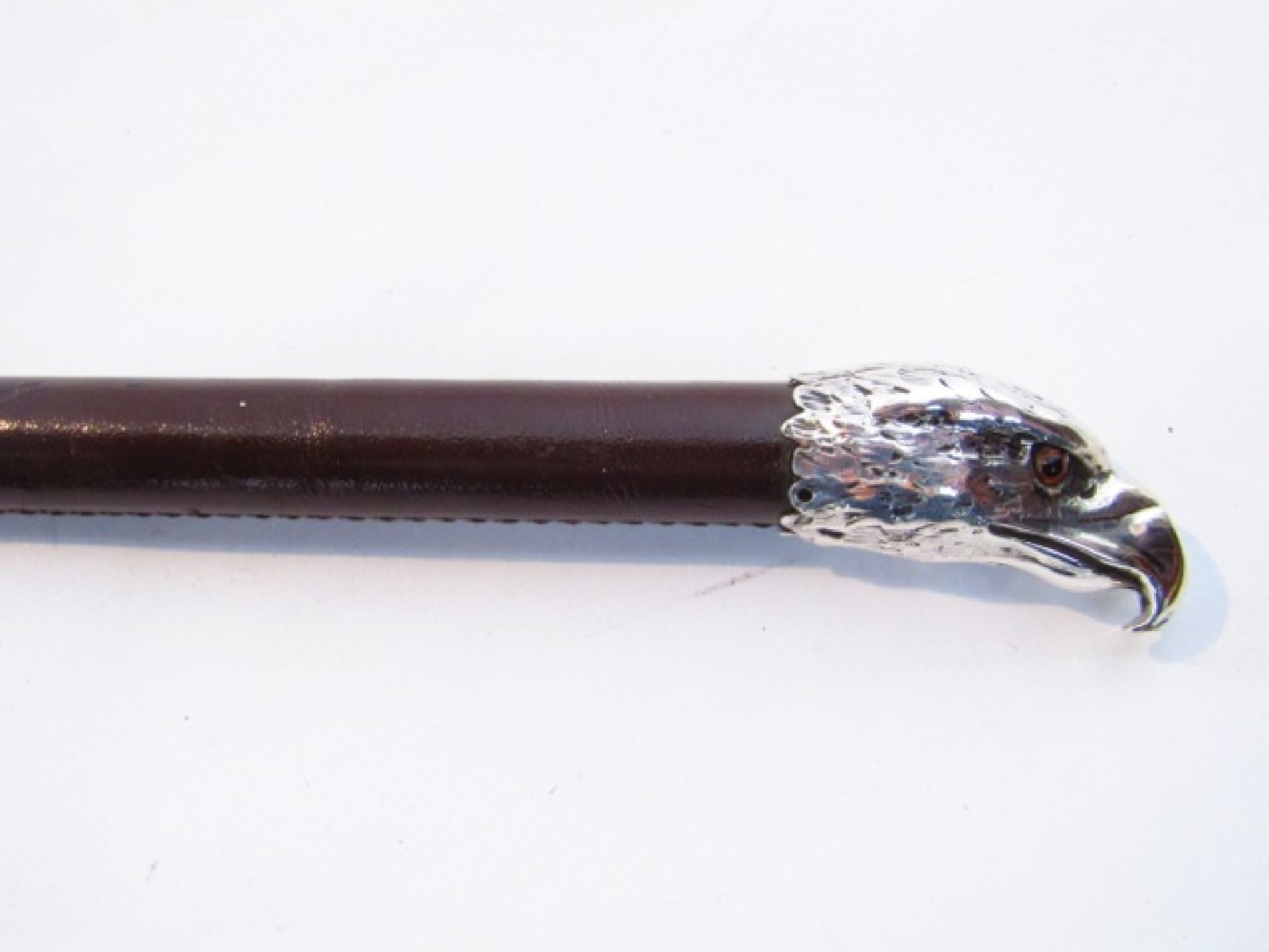 Appraisal: A stitched leather clad swagger stick with a silver collar