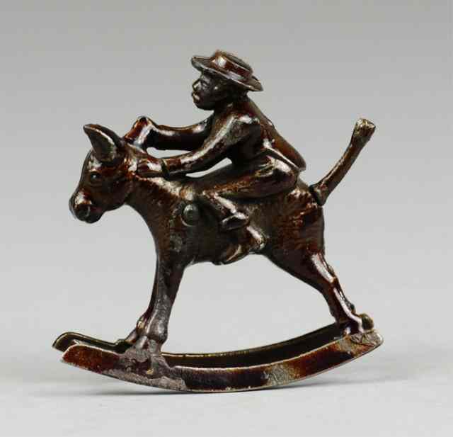 Appraisal: IVES BOY RIDING MULE Cast iron japanned finish classic ''Whoa