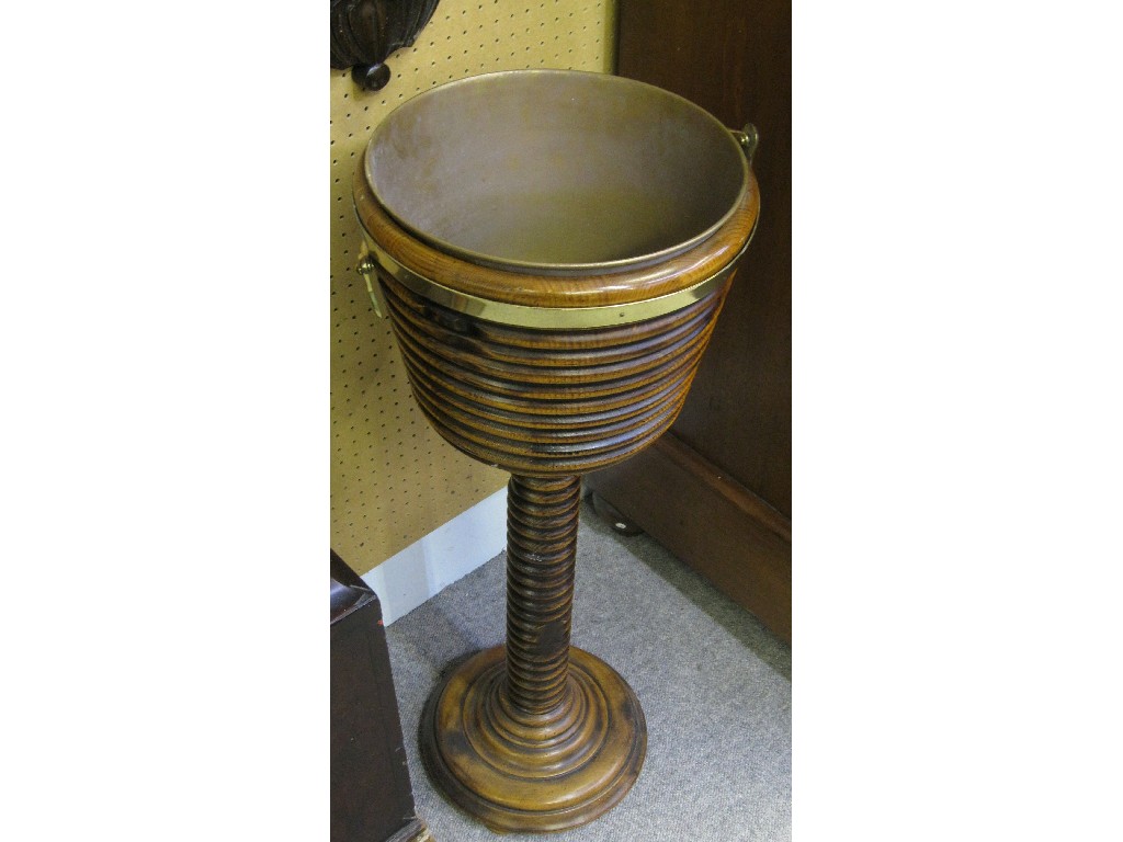 Appraisal: Walnut and brass mounted jardiniere stand with ribbed decoration