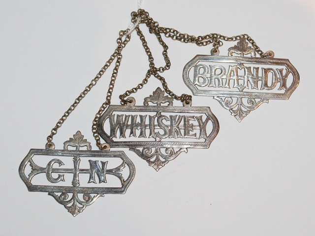 Appraisal: A SET OF THREE DECANTER LABELS pierced Brandy Gin and