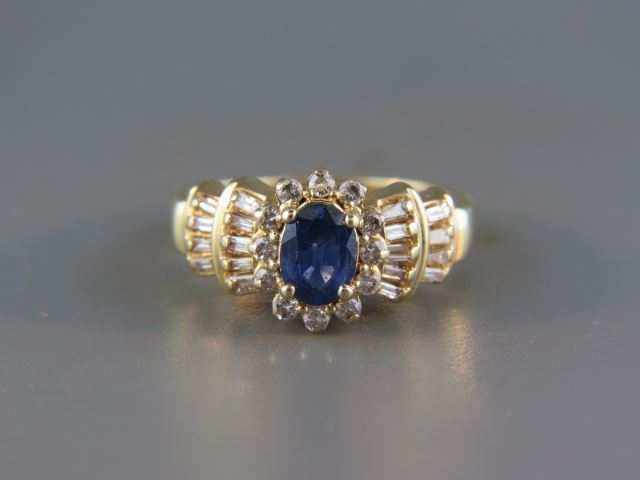 Appraisal: Sapphire and Diamond Ring rich carat blue gem surrounded by