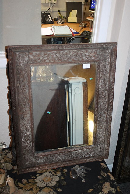 Appraisal: A BURMESE CARVED HARDWOOD FRAME WALL MIRROR with foliate decoration