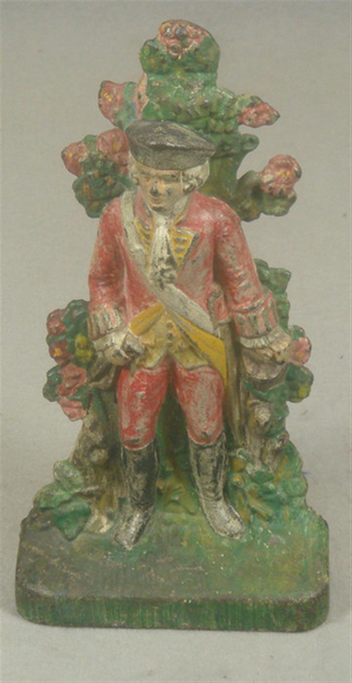 Appraisal: Cast iron doorstop Colonial Officer in full uniform with foliage