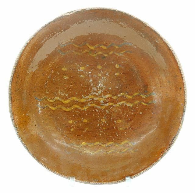 Appraisal: American slip-decorated redware pottery pie plate Pennsylvania th c having