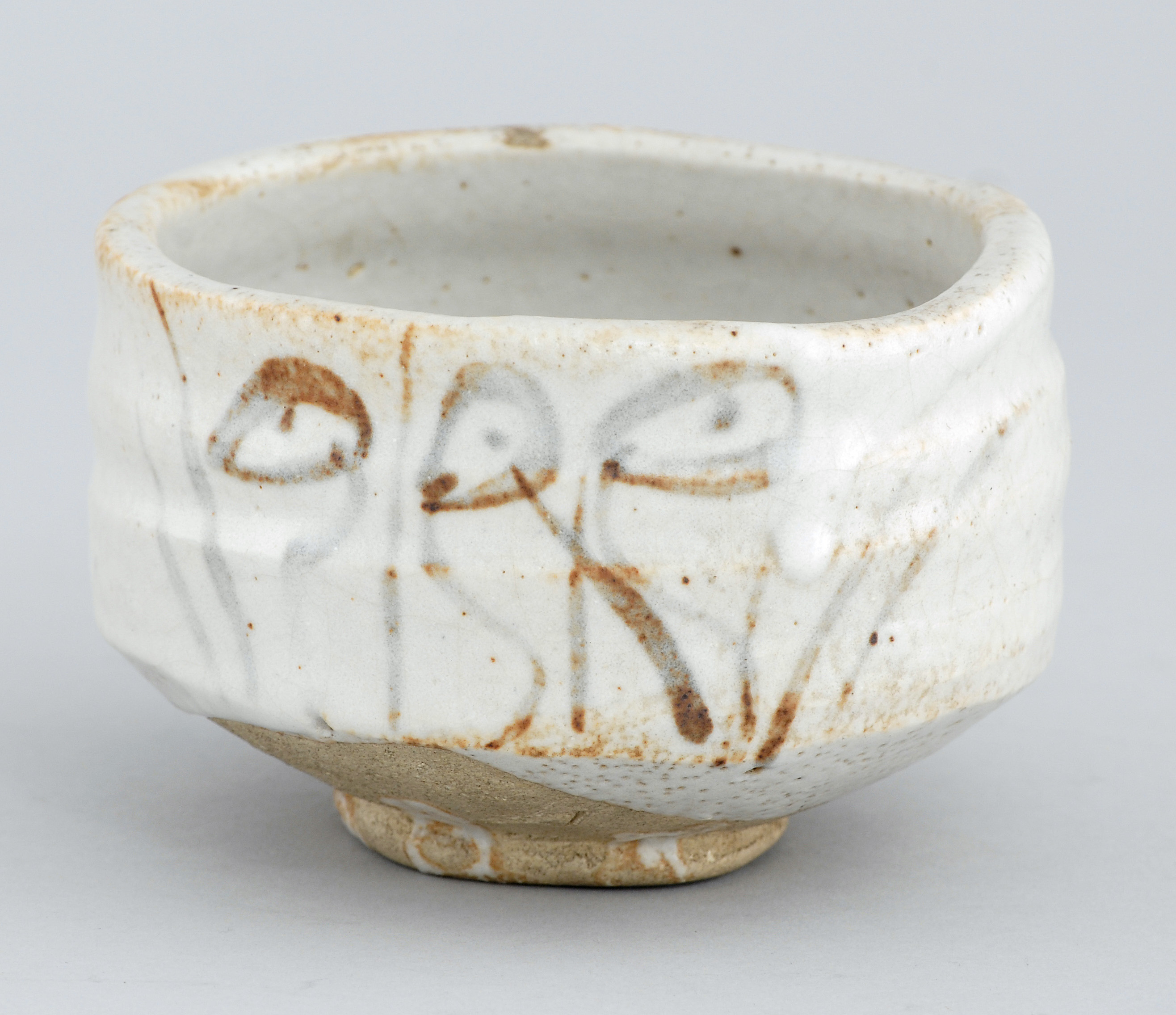 Appraisal: SHINO POTTERY CHAWAN With grasses and flower decoration Potter's mark