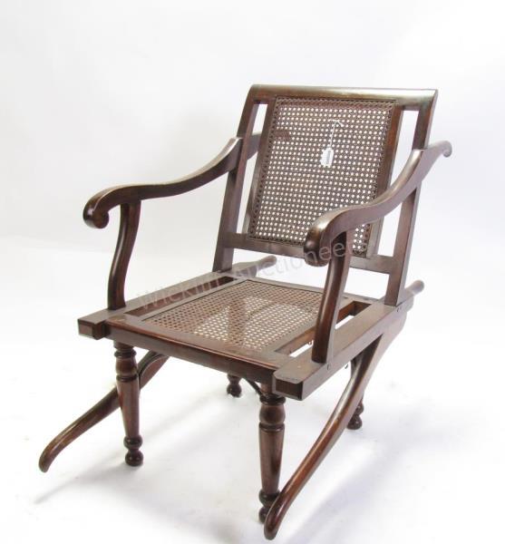 Appraisal: An antique invalid chair with carry handles front and back