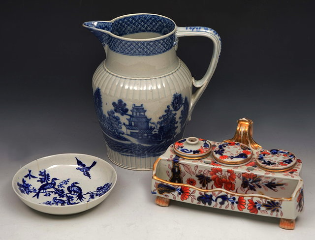 Appraisal: A STAFFORDSHIRE BLUE GLAZE JUG with oriental landscape decoration by