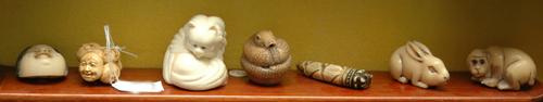 Appraisal: A COLLECTION OF SEVEN IVORY AND BONE NETSUKE AND FIGURES