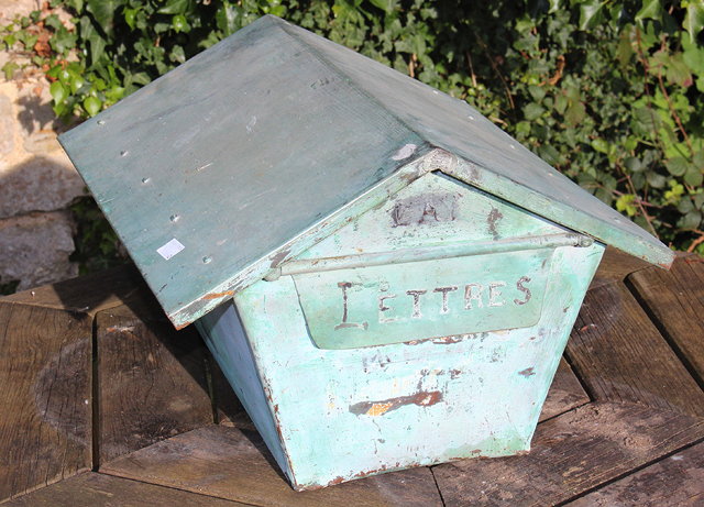 Appraisal: A COPPER GATE POST LETTERBOX with pitched roof flap to