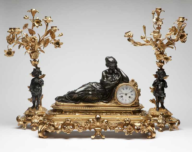 Appraisal: A French patinated and gilt bronze mantel clock and garniture