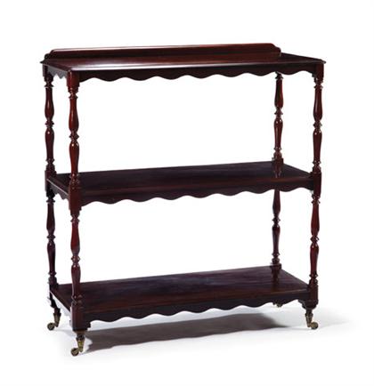 Appraisal: English mahogany whatnot The three rectangular open shelves with carved