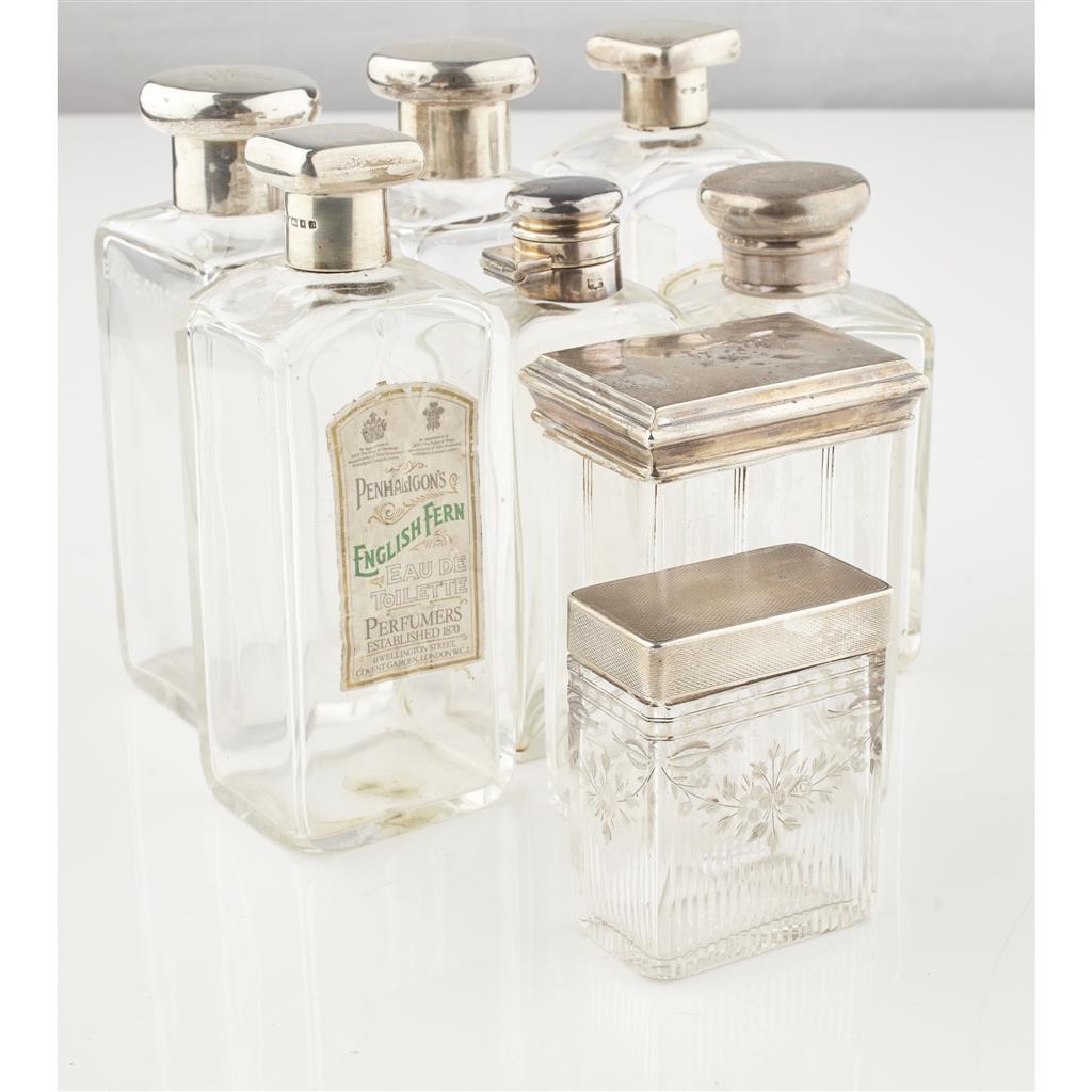 Appraisal: A collection of silver topped glass bottles the glass bottles