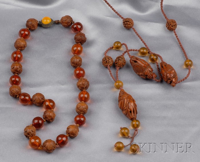 Appraisal: Two Carved Peach Pit and Amber Bead Necklaces one with