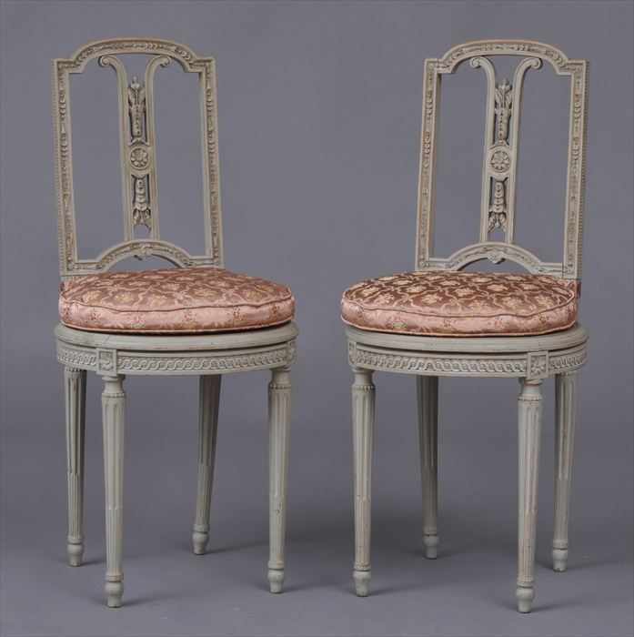 Appraisal: PAIR OF LOUIS XVI-STYLE CARVED AND GRAY-PAINTED CHAISES Each bowed