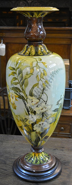 Appraisal: An Austrian yellow pottery tall vasewith flower designs on hardwood