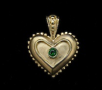 Appraisal: K Gold and Tsavorite Pendant K yellow gold heart-shaped pendant