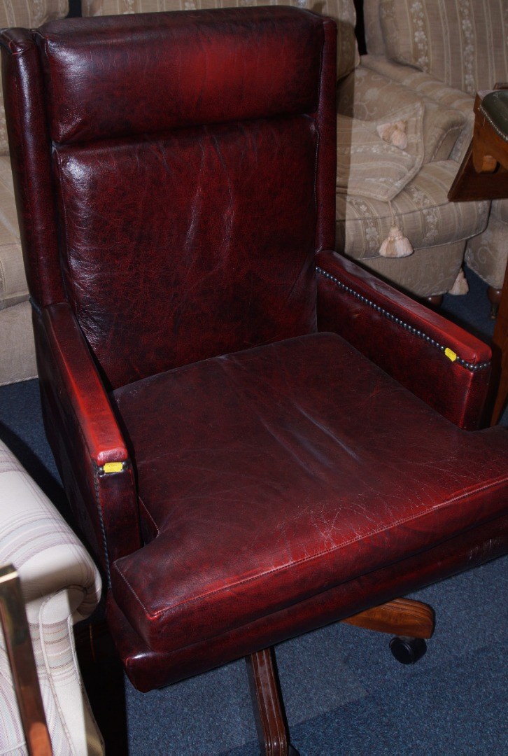 Appraisal: A red leather brass studded office chair raised on a