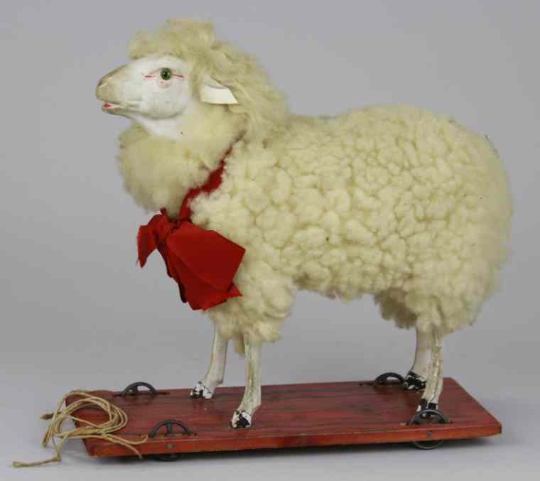 Appraisal: LAMB ON PLATFORM Wool covered lamb figure stands on wood