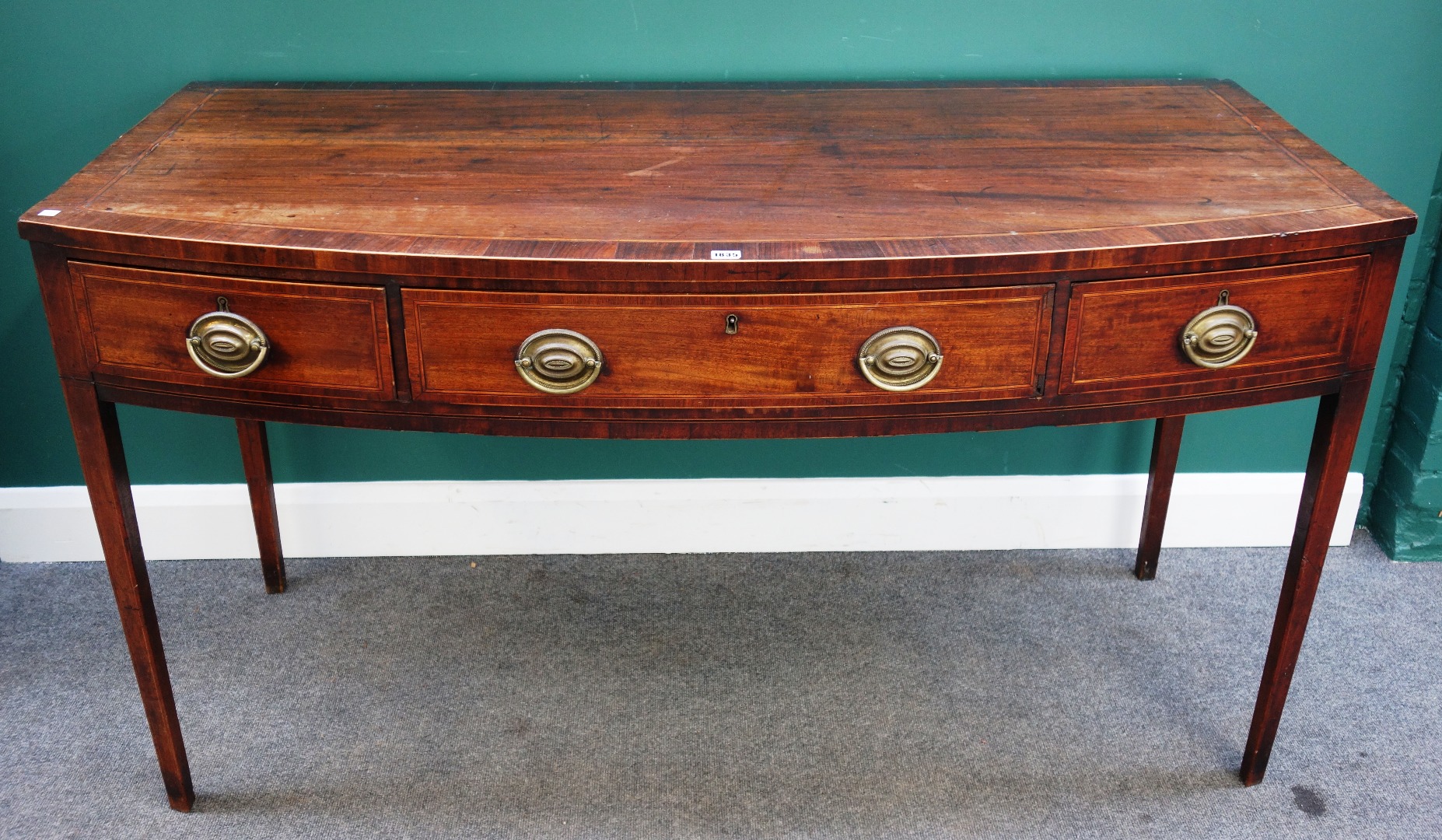 Appraisal: A George III inlaid mahogany bowfront three drawer serving table