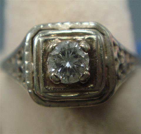 Appraisal: Unmarked K WG filigree diamond ring about a pt stone