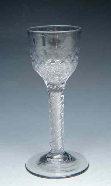 Appraisal: A HONEYCOMB MOULDED WINE GLASS on double series air twist