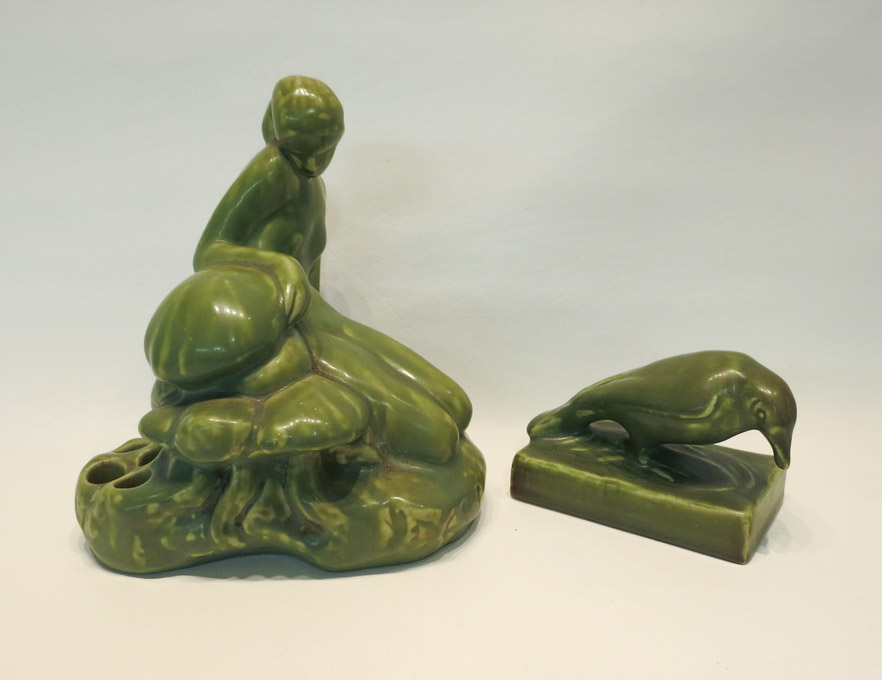 Appraisal: TWO ROOKWOOD POTTERY GLAZED FIGURES the first of a seated