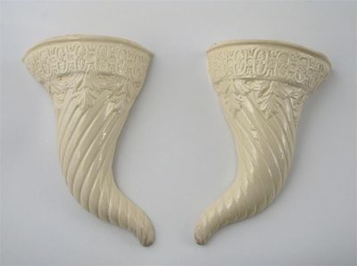 Appraisal: A pair of creamware cornucopia wall vases moulded with a