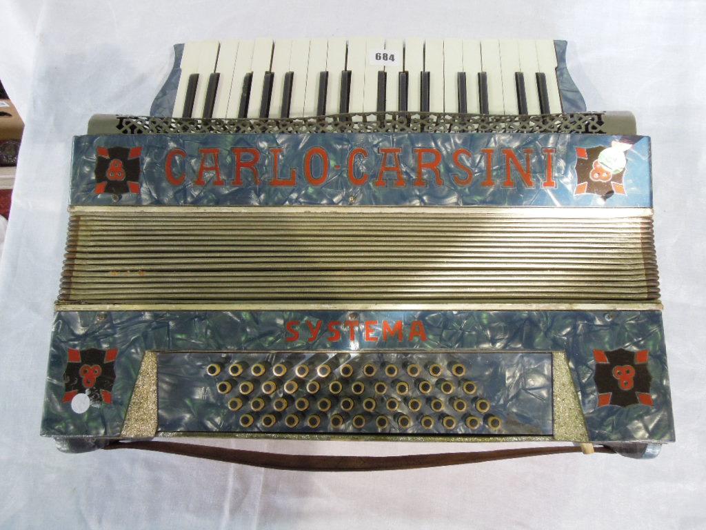 Appraisal: An accordion made by Carlo Carsini in a blue pearlised