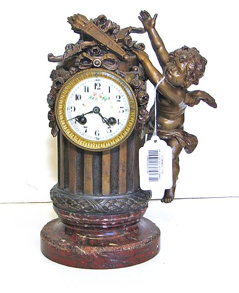 Appraisal: A French painted white metal and marble mantel clock first