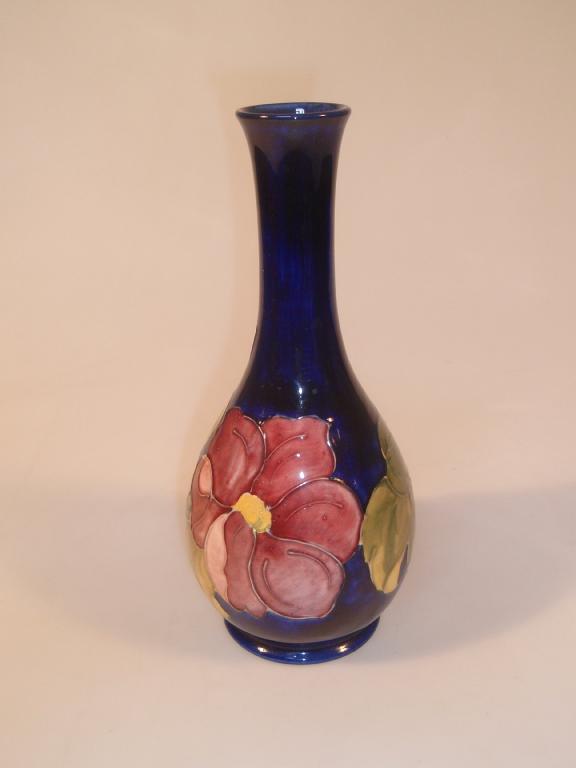 Appraisal: Moorcroft A long necked vase decorated with magnolia dark blue