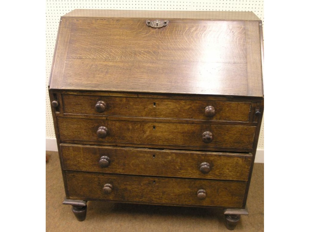 Appraisal: An early th Century oak bureau fall-front enclosing mahogany drawers