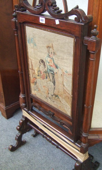 Appraisal: A Victorian rosewood framed firescreen with turned column and pierced