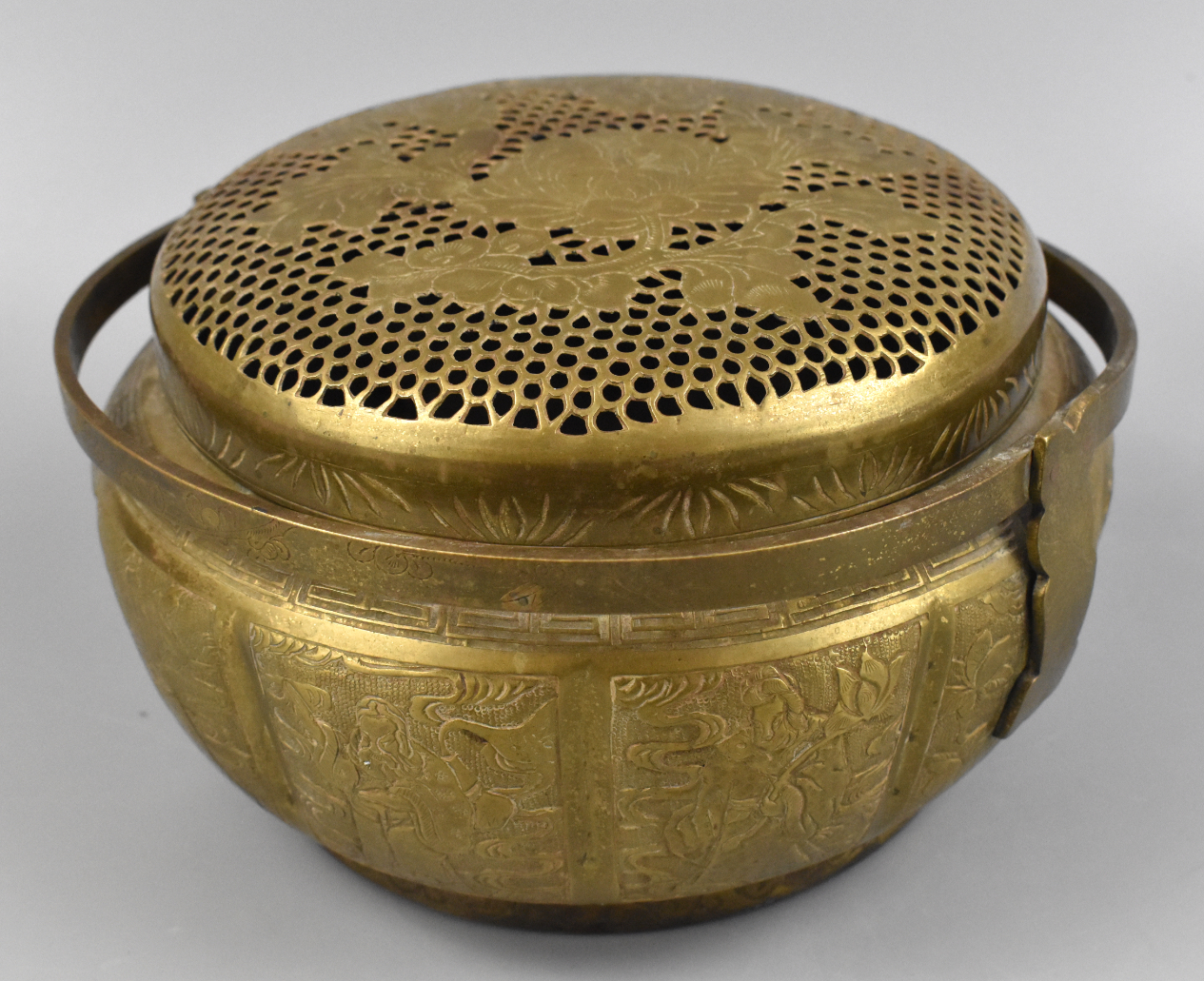 Appraisal: A Chinese bronze hand warmer with the immortals around body