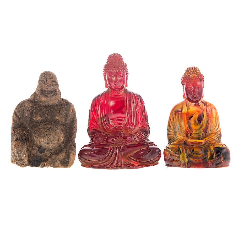 Appraisal: Three Buddhas including cherry resin seated Buddha mottled resin seated