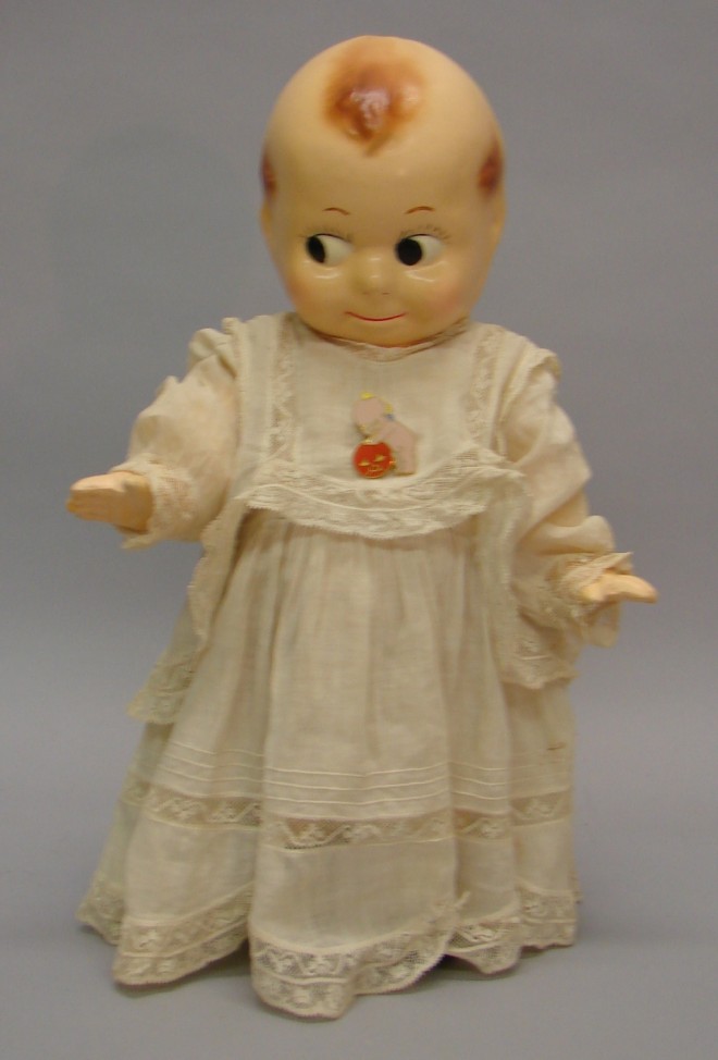 Appraisal: Unmarked Kewpie style doll with strung arms Painted features side