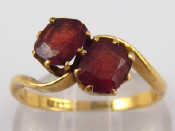 Appraisal: A yellow metal tests carat gold two stone garnet ring