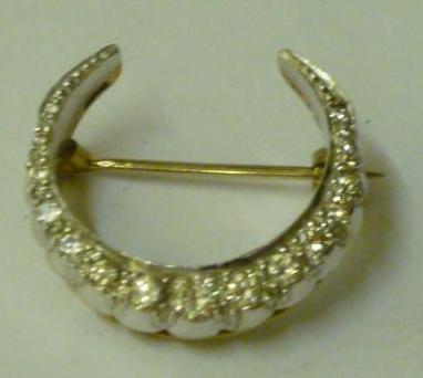 Appraisal: A DIAMOND CRESCENT BROOCH having graduated round cut diamonds in