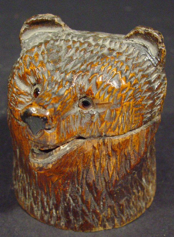 Appraisal: Black Forest carved wooden bear's head inkwell set with glass