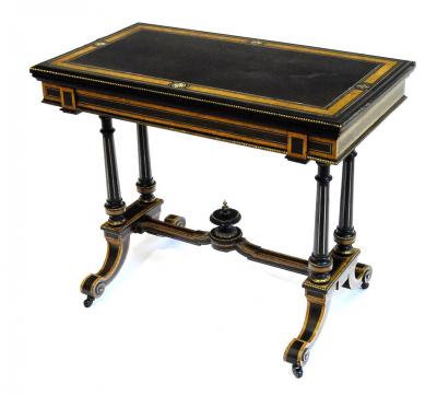 Appraisal: AN AESTHETIC FOLDING CARD TABLE in ebony with amboyna banding