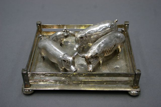 Appraisal: A novelty sterling silver condiment set formed as pig within