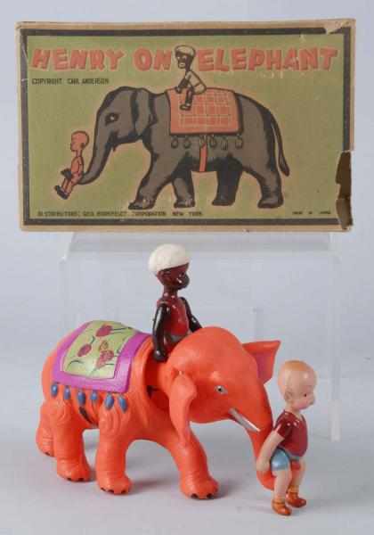 Appraisal: Celluloid Henry on Elephant Wind-Up Toy Description Japanese Pre-war Orange