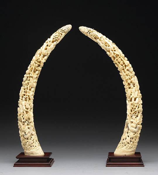 Appraisal: A pair of carved ivory tusks The reticulated design of