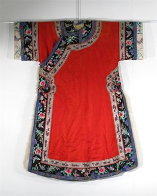 Appraisal: A Chinese red silk coat with floral borders and lined