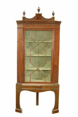 Appraisal: A George III mahogany corner cupboard the fluted pediment with