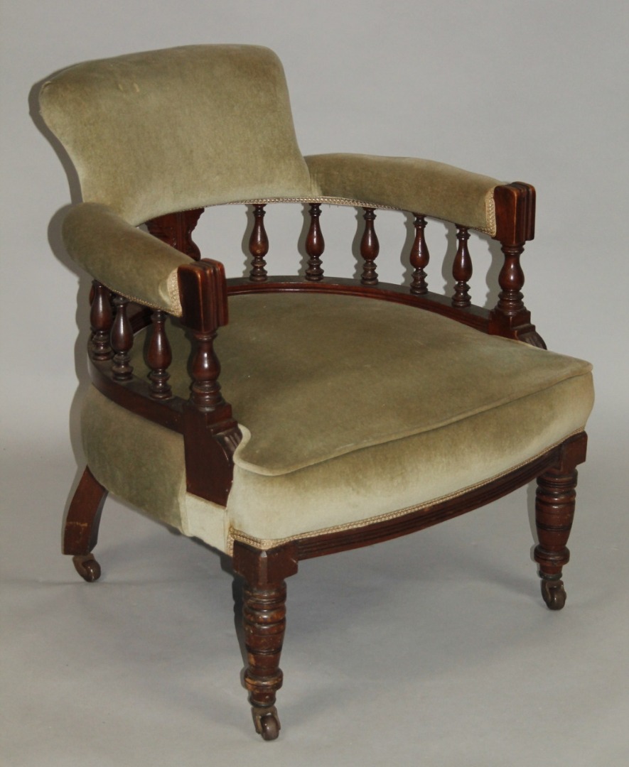 Appraisal: An Edwardian walnut framed tub chair with 'C' scroll back