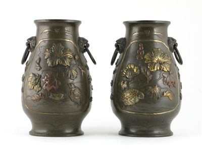 Appraisal: A pair of Japanese bronze ovoid vases with loose ring