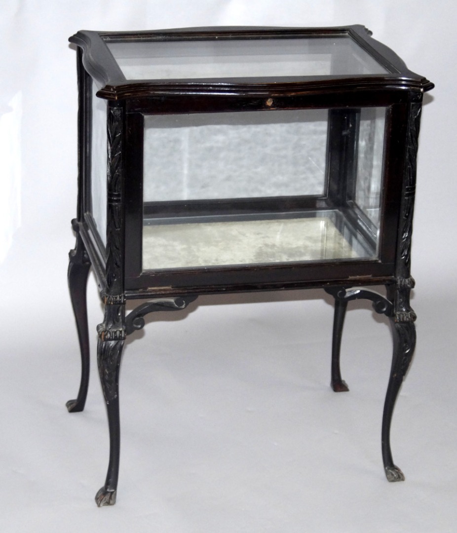 Appraisal: A Victorian ebonised serpentine bijouterie cabinet corner verticals leaf carved