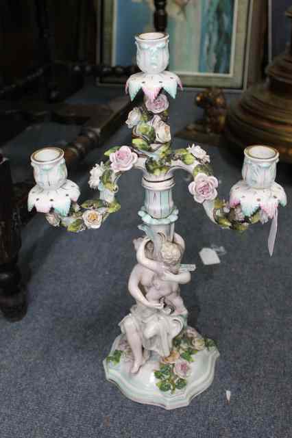 Appraisal: A CONTINENTAL PORCELAIN THREE LIGHT CANDELABRA with two flower encrusted