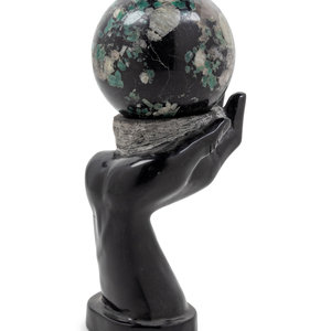 Appraisal: A Carved Hardstone Ornament Depicting a Globe in the Palm