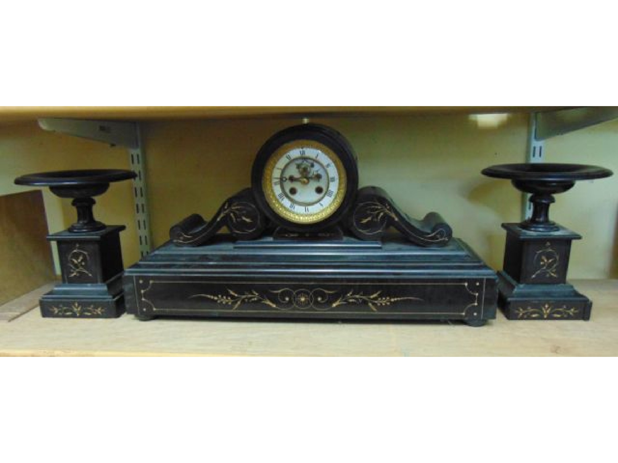 Appraisal: A Victorian black slate clock garniture the clock held within